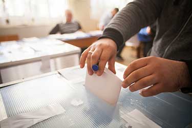 Person adding ballot into ballot box